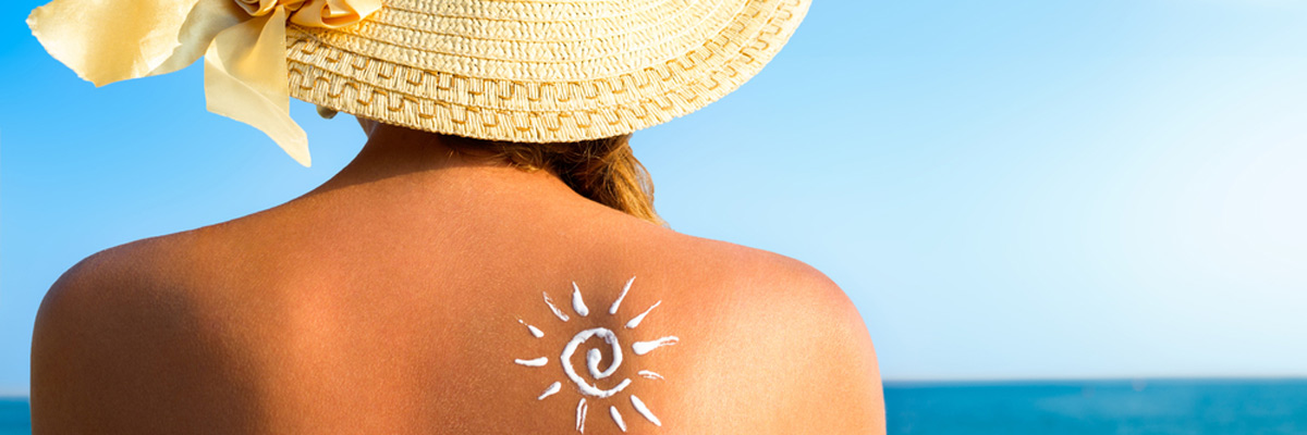 Suntan lotion woman with sunscreen solar cream over ocean background